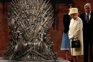 Britain's Queen Elizabeth looks at the Iron Throne as she meets members of the cast on the set of the television show Game of Thrones in the Titanic Quarter of Belfast